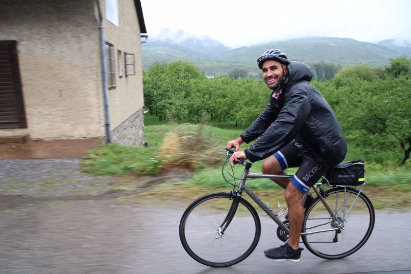 Our intrepid Backgroads guide Evan Thompson rding with a smile in the rain (photo by Virginia Meyer)