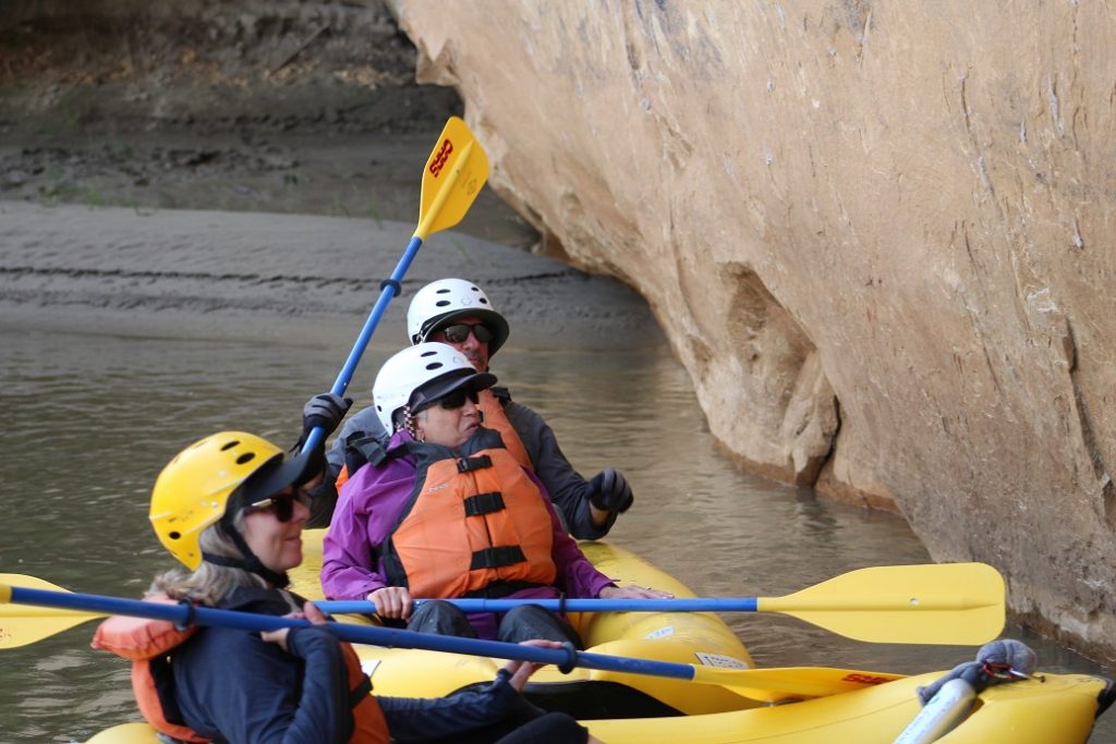 Barb Engbretson, Eileen Ogintz and Layne Lisenbee in kayaks near Yampa Canyon wall